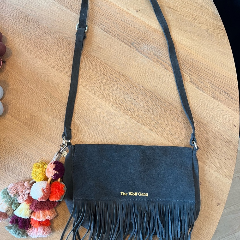 The Wolf Gang Charcoal Crossbody Bag with Fringe and Pom-Poms